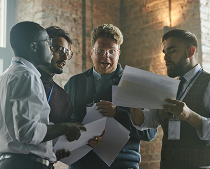 group-of-colleagues-discussing-documents-in-an-industrial-style-office-0wpwkK-k7Km6Y8AOCyLwBA